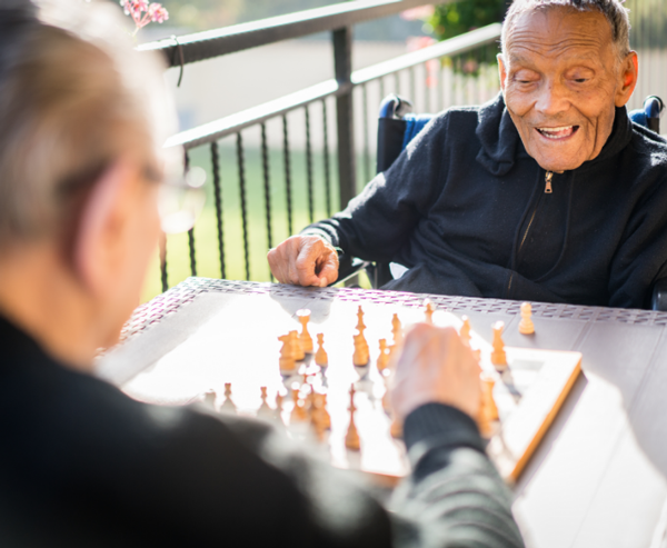 Two patients happily playing chess